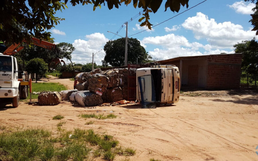 Caminhão carregado com materiais recicláveis tomba ao passar por buraco
